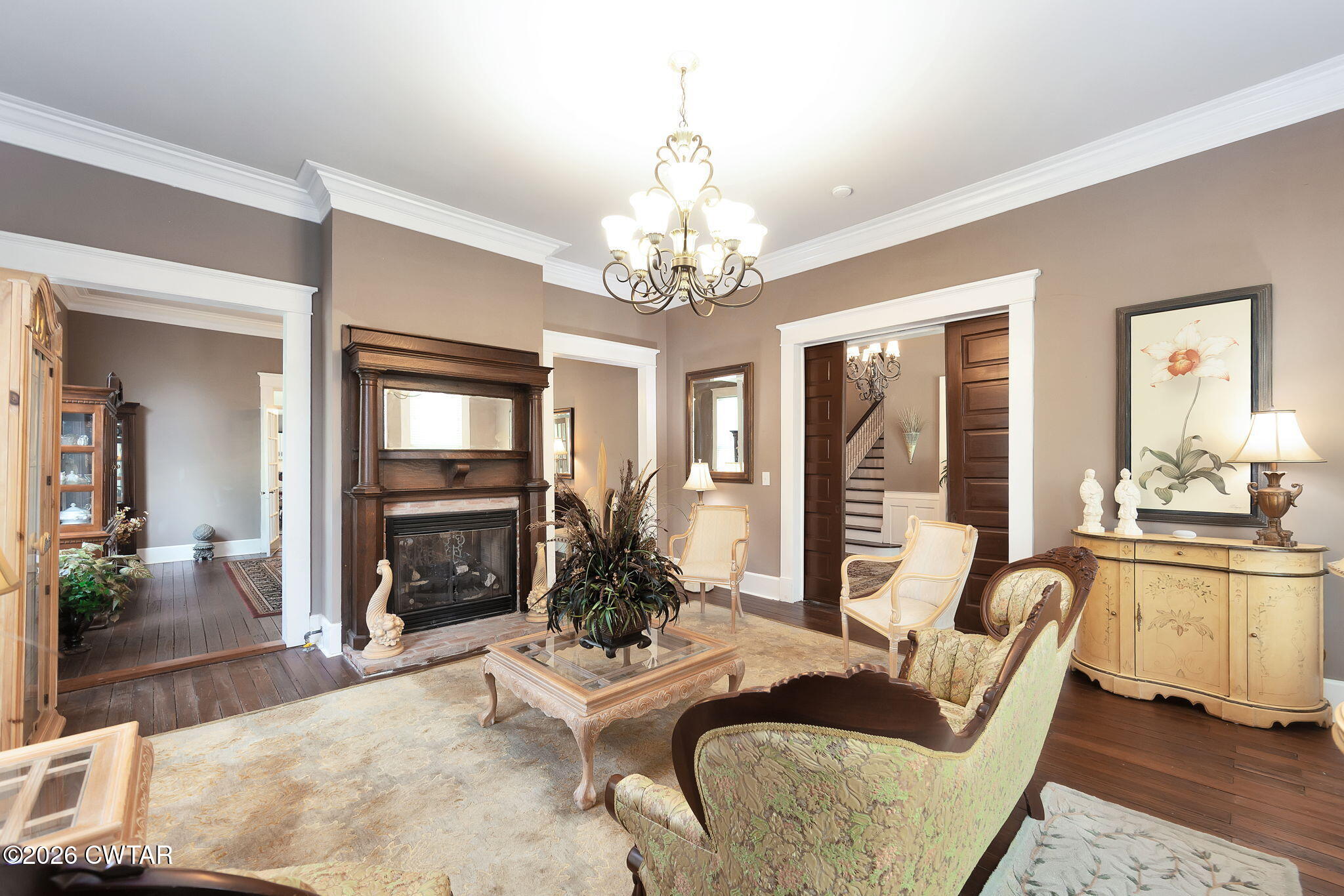 554 East Main Street Jackson, TN 38301 - Photo 9 of 60 a living room with furniture a chandelier and a dining table