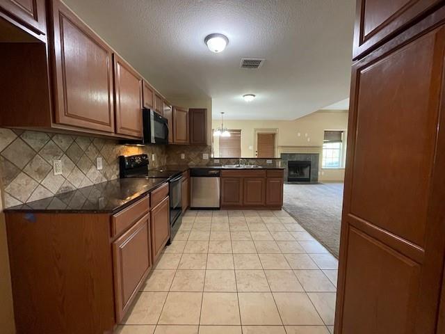 3953 Vista Mar Drive Fort Worth, TX 76040 - Photo 10 of 26 a large kitchen with stainless steel appliances granite countertop a stove a sink dishwasher and a refrigerator