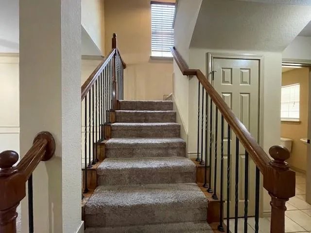 a large kitchen with stainless steel appliances granite countertop a stove a sink dishwasher and a refrigerator