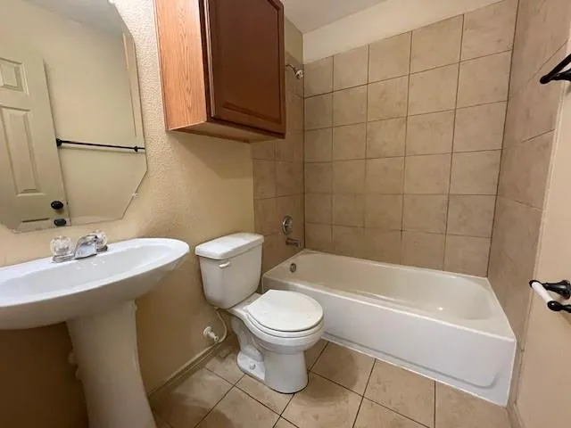 a bathroom with a sink a toilet and a bathtub