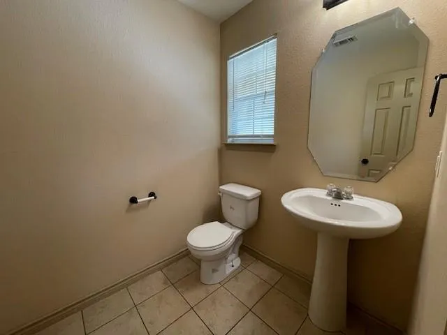 a bathroom with a sink toilet and a mirror