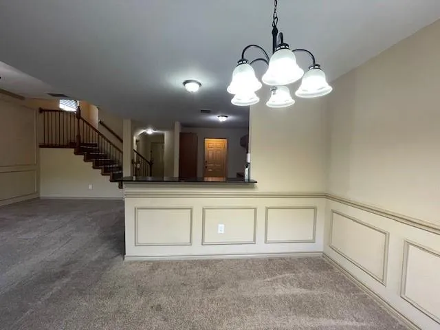 a view of a room with a sink and mirror