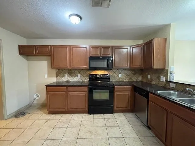 a view of a kitchen with a sink and dishwasher