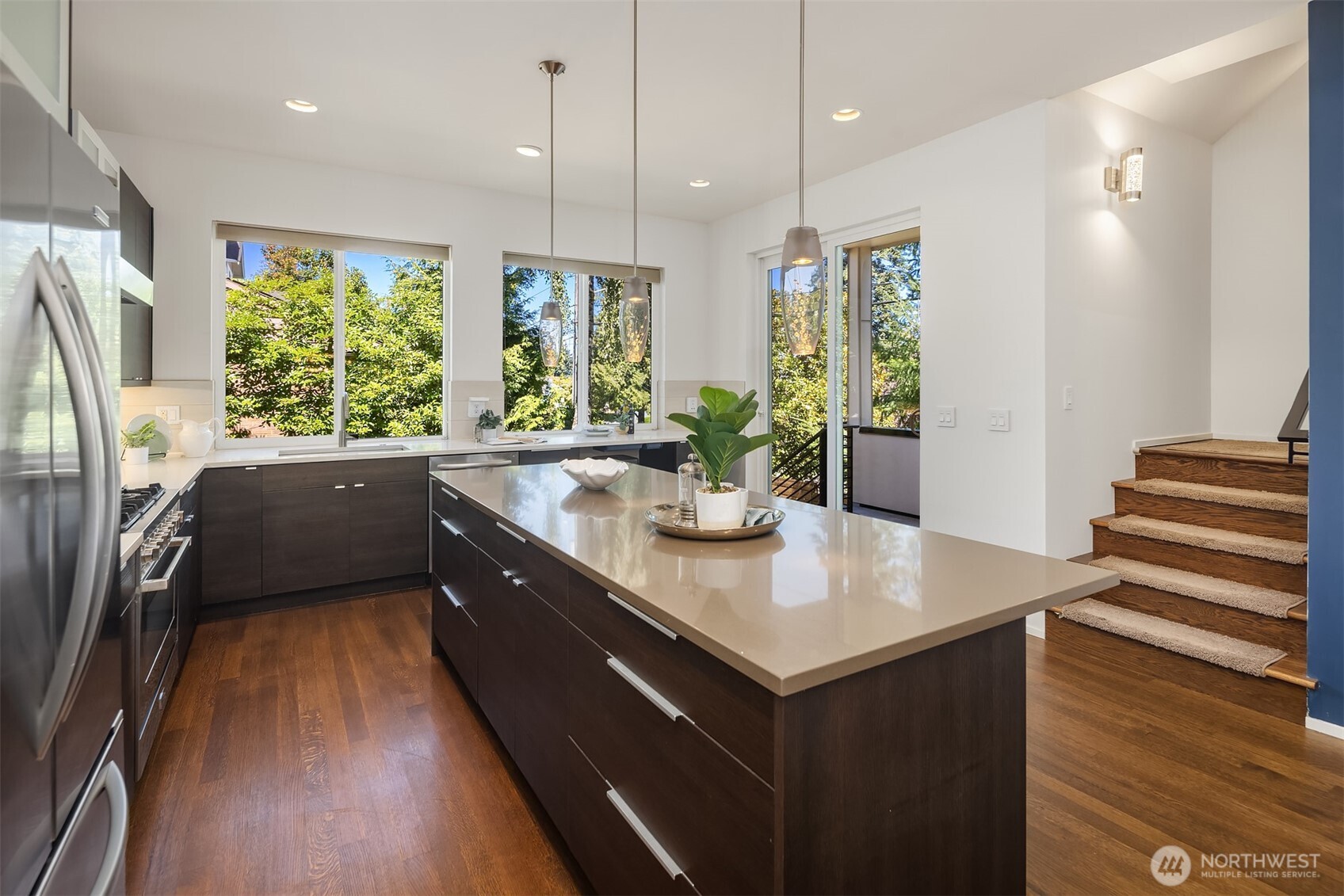1256 Northeast 89th Street Seattle, WA 98115 - Photo 14 of 37 a kitchen with a refrigerator a sink and wooden floor