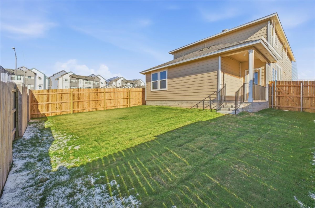 2601 Towy Road Pflugerville, TX 78660 - Photo 29 of 29 Rear view of property featuring a fenced backyard, a residential view, and entry steps.