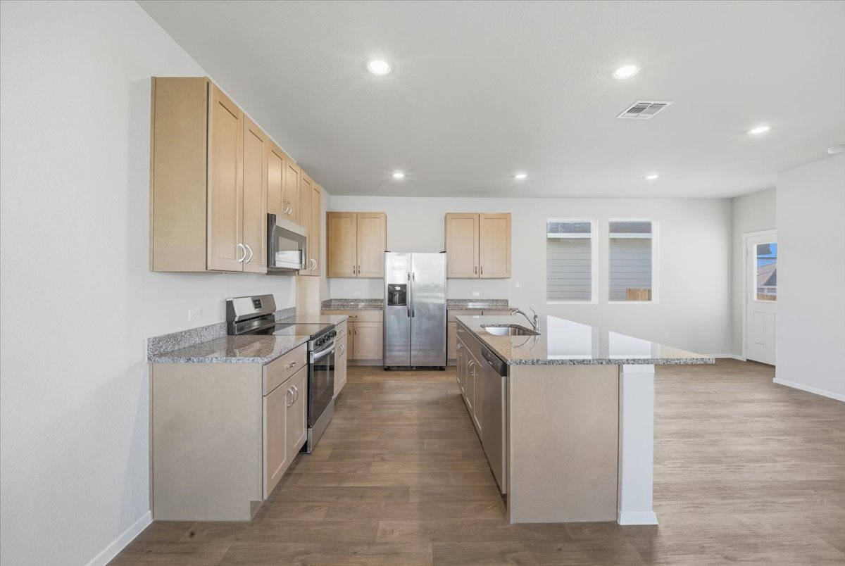 2601 Towy Road Pflugerville, TX 78660 - Photo 5 of 29 Spacious open kitchen with stainless steel appliances, light wood finish cabinets.