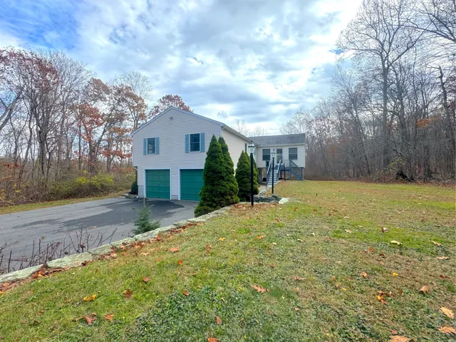 a front view of a house with a yard garage and outdoor seating
