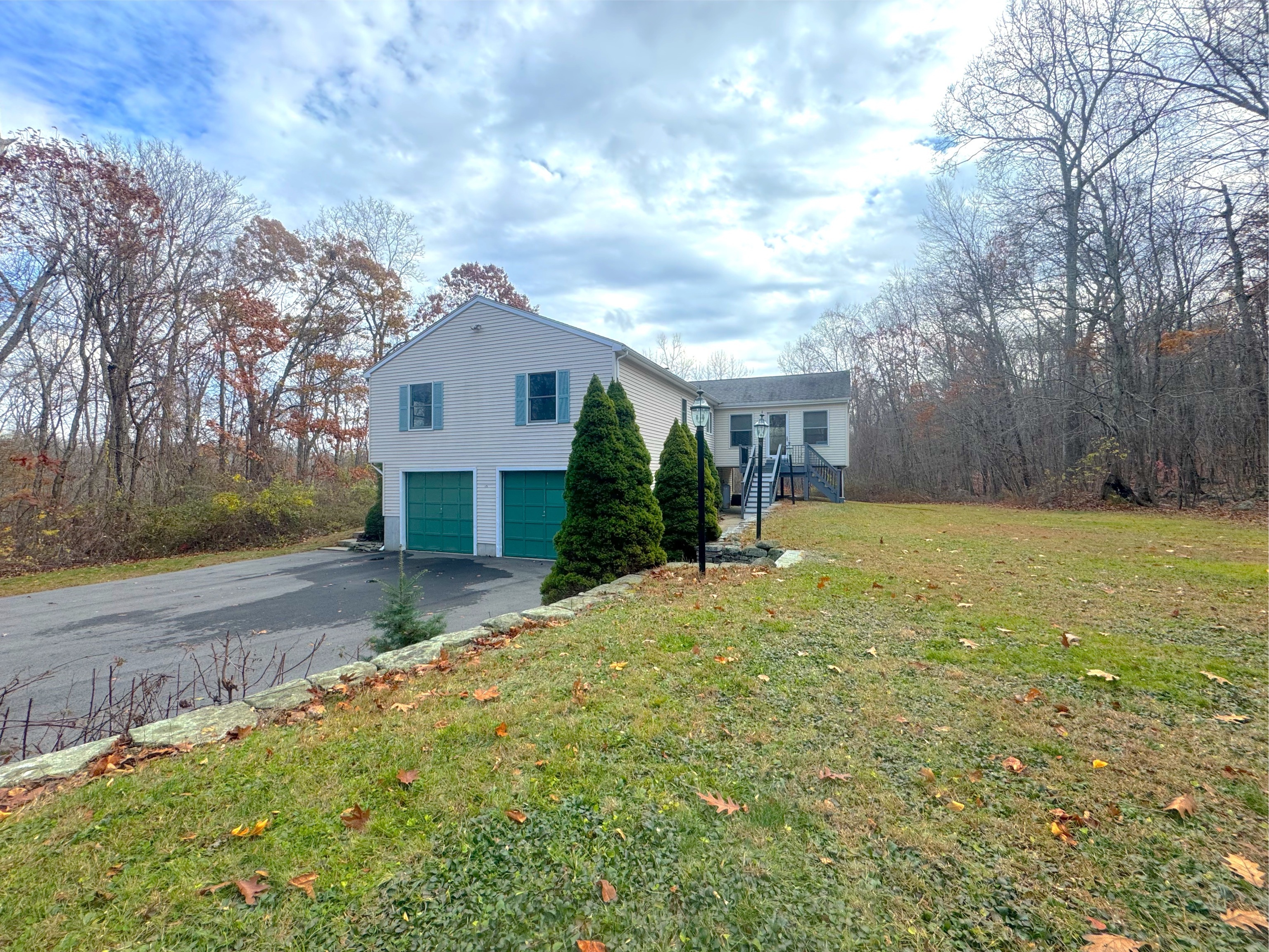 400 Windham Avenue Colchester, CT 06415 - Photo 3 of 33 a front view of a house with a yard garage and outdoor seating