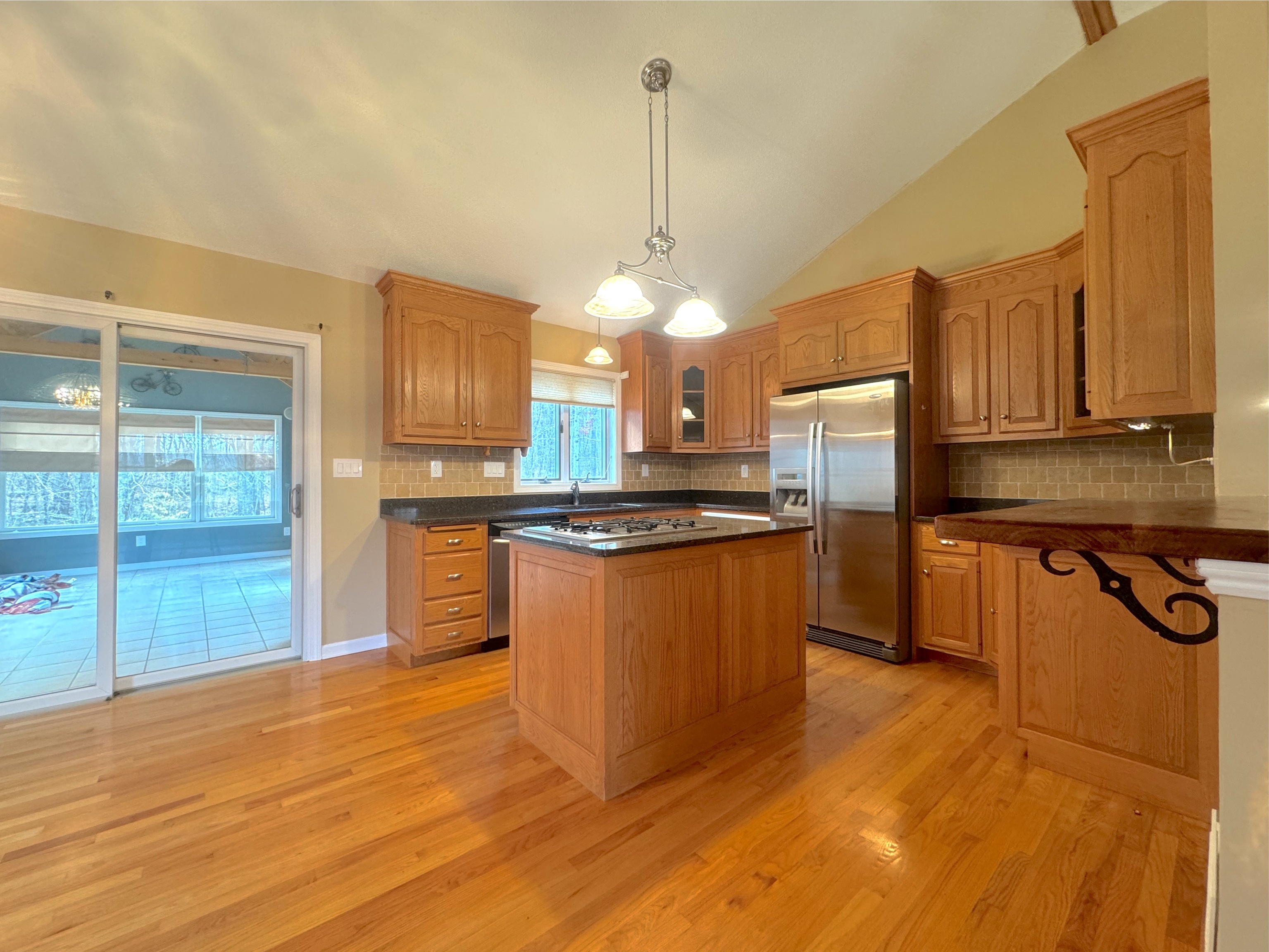 400 Windham Avenue Colchester, CT 06415 - Photo 8 of 33 a kitchen with stainless steel appliances granite countertop a sink a stove a refrigerator cabinets and living room view