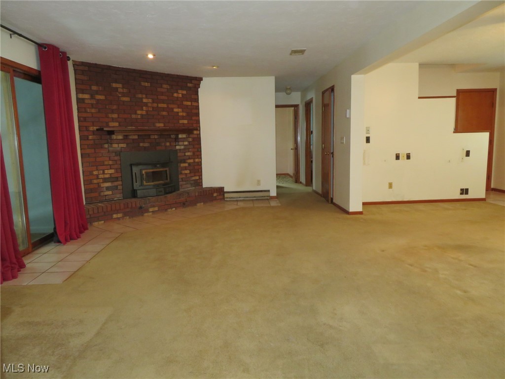 38505 Sugar Ridge Road North Ridgeville, OH 44039 - Photo 9 of 44 A woodburner insert accents the corner of the Family room that is open to the living room and dining area