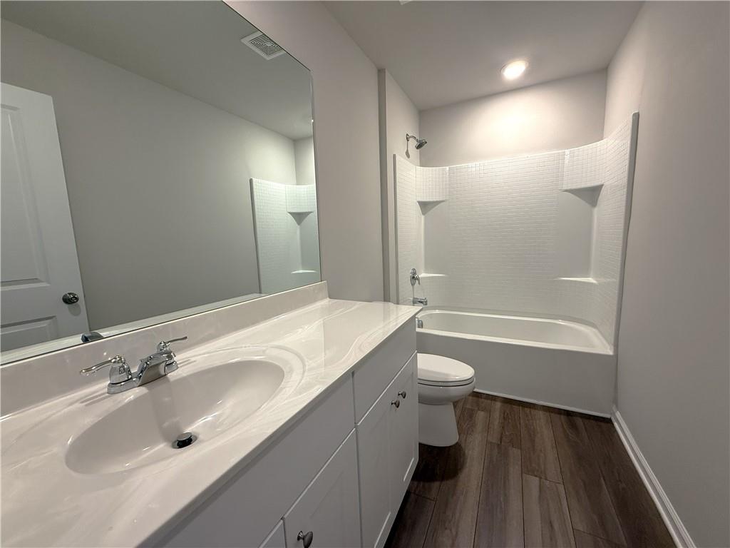 108 Seed Lane Pendergrass, GA 30567 - Photo 11 of 15 a bathroom with a double vanity sink toilet mirror and bathtub