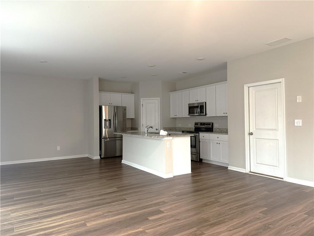 108 Seed Lane Pendergrass, GA 30567 - Photo 3 of 15 a view of kitchen with microwave refrigerator and cabinets