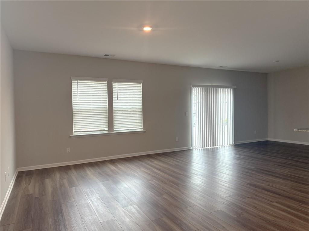 108 Seed Lane Pendergrass, GA 30567 - Photo 5 of 15 an empty room with wooden floor and windows