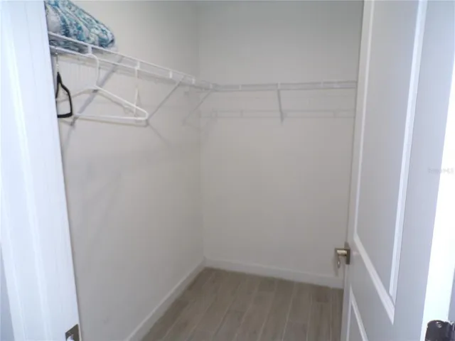 a bedroom with a bed and a chair