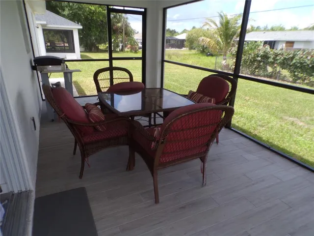 a view of a chairs and table in patio