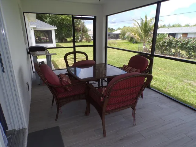a living room with furniture and a mirror