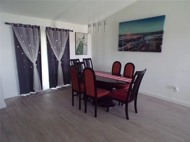 a view of a dining room with furniture and window