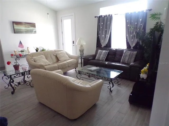 a living room with furniture and a lamp