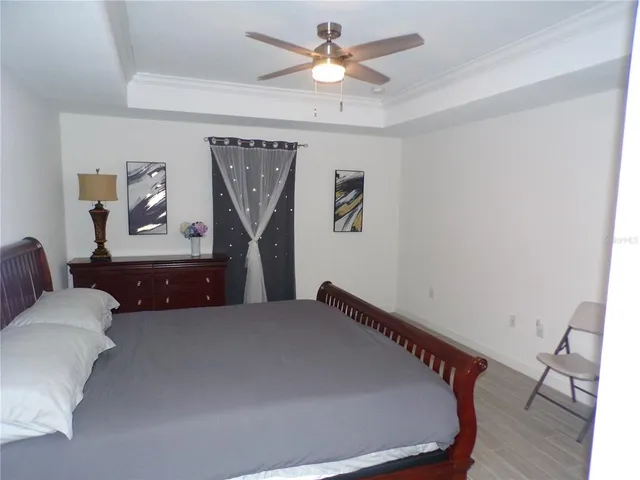 a room with a bed and a chandelier