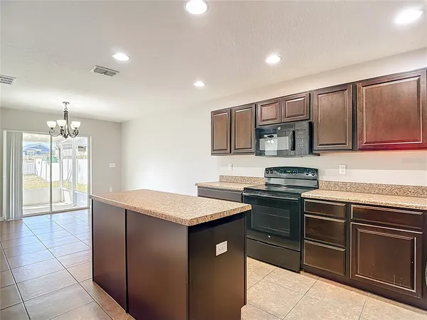 a kitchen with stainless steel appliances granite countertop wooden cabinets a stove top oven a sink and dishwasher