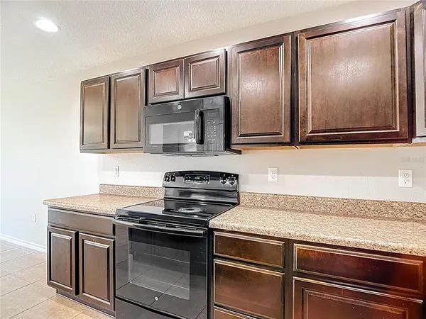 a kitchen with granite countertop a sink and stainless steel appliances