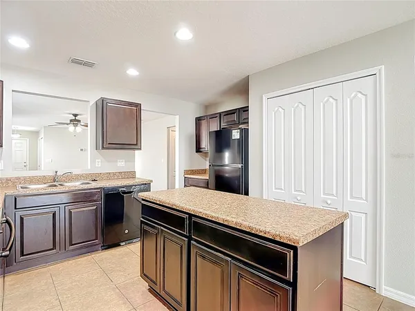 a kitchen that has a sink and a stove top oven