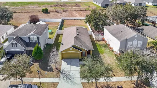 an aerial view of multiple houses with a yard