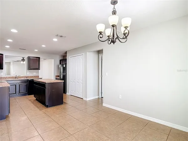 an empty room with cabinet and a ceiling fan