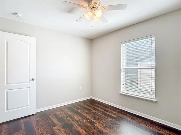 a view of closet area with wooden floor