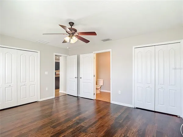 a room with wooden floor and cabinets