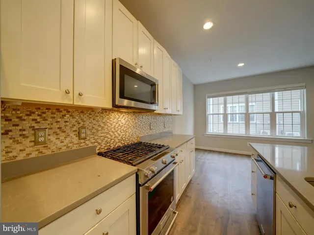 a kitchen with a refrigerator and a sink
