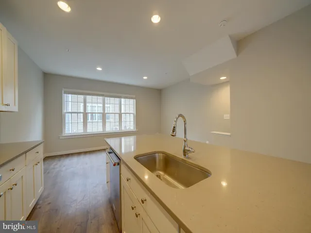 a kitchen with stainless steel appliances a stove microwave and sink