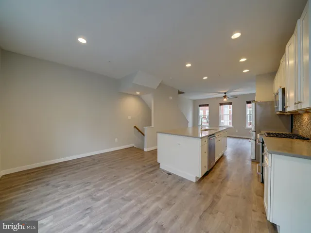 a view of kitchen and kitchen with a sink wooden floor