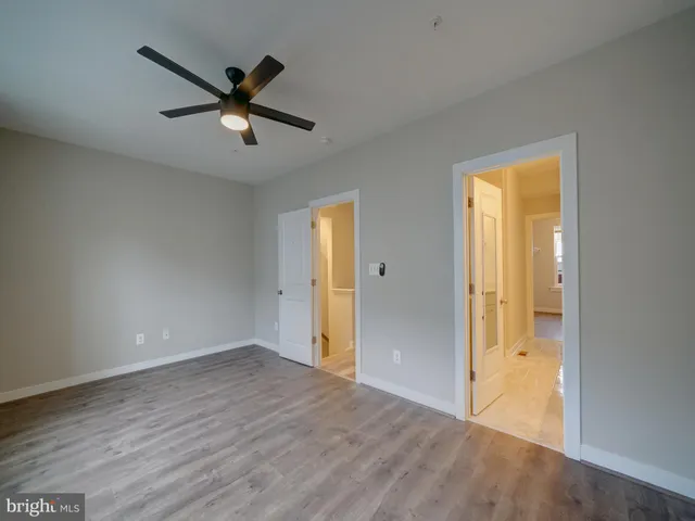 a view of a small space with wooden floor and a window