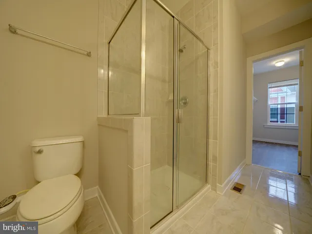 wooden floor in an empty room with a kitchen