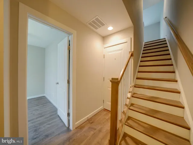 a view of a house with a parking space in front of it