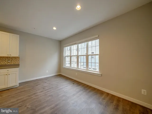 a view of a kitchen with center island and stainless steel appliances