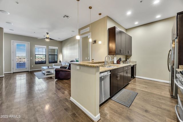 a large kitchen with a large counter top appliances and cabinets