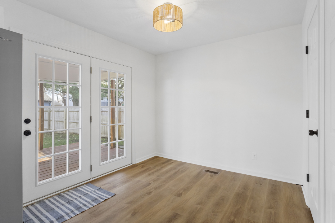 2803 Maplewood Drive Champaign, IL 61821 - Photo 20 of 39 a view of an empty room with wooden floor and a window