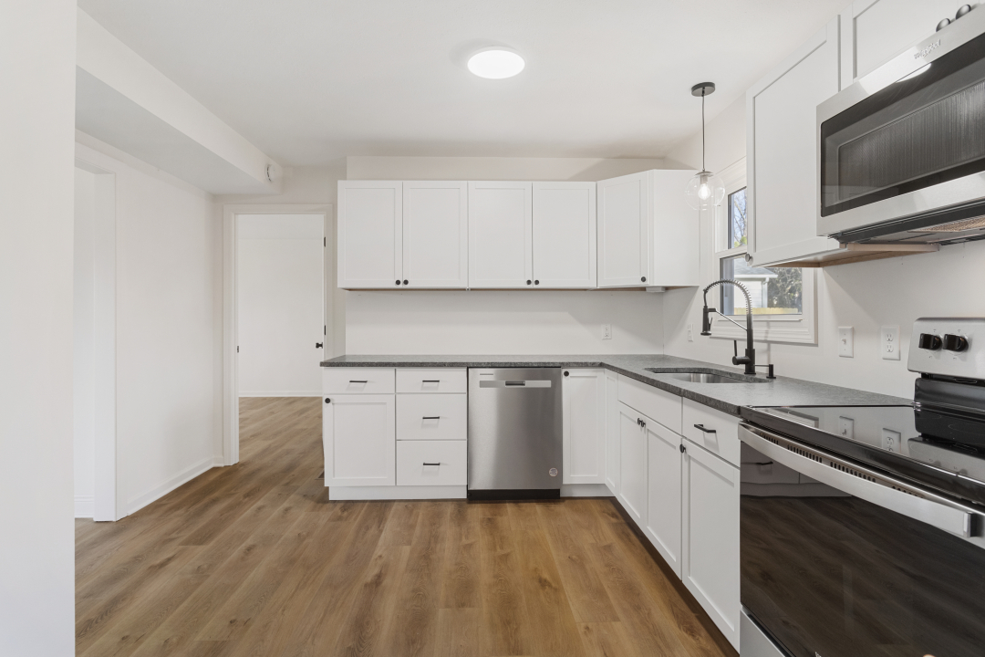 2803 Maplewood Drive Champaign, IL 61821 - Photo 22 of 39 a kitchen with granite countertop cabinets stainless steel appliances and a sink