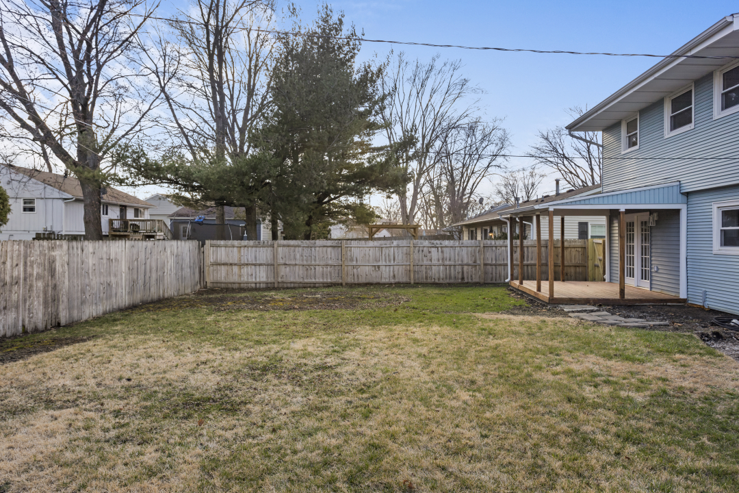 2803 Maplewood Drive Champaign, IL 61821 - Photo 35 of 39 a view of a yard with a large tree and wooden fence