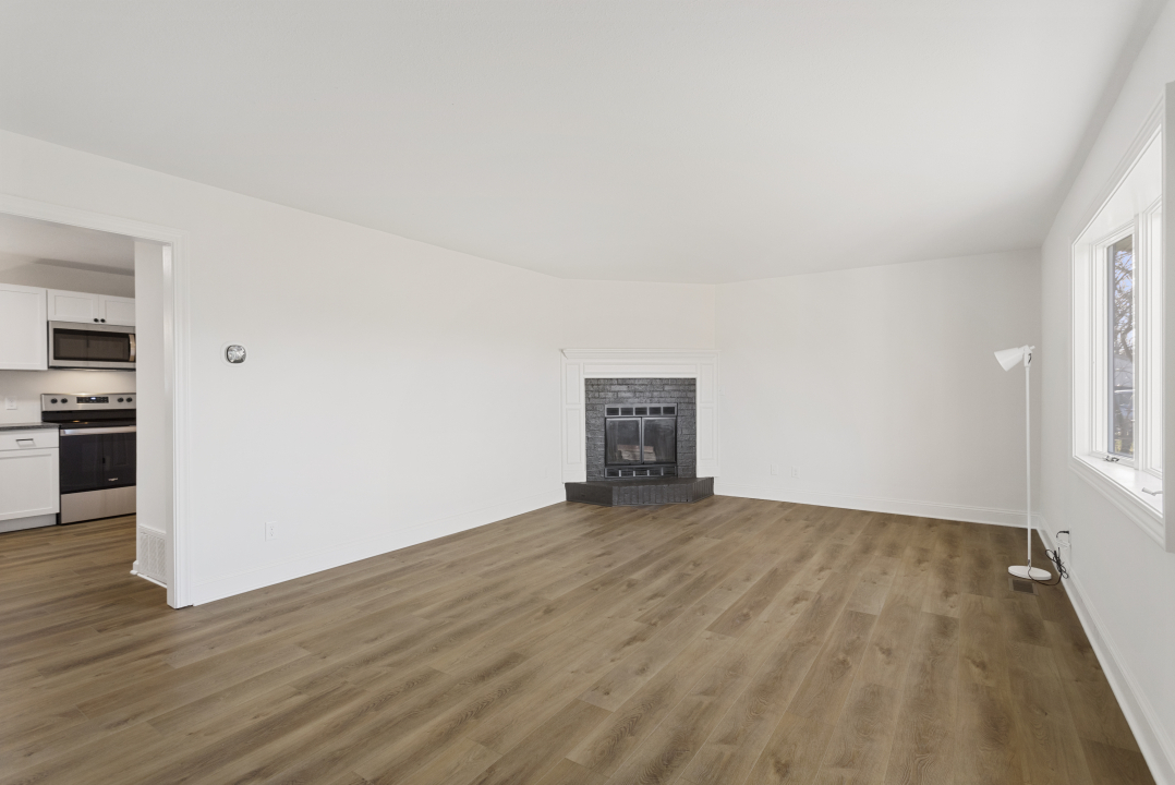 2803 Maplewood Drive Champaign, IL 61821 - Photo 4 of 39 a view of an empty room with wooden floor and a window