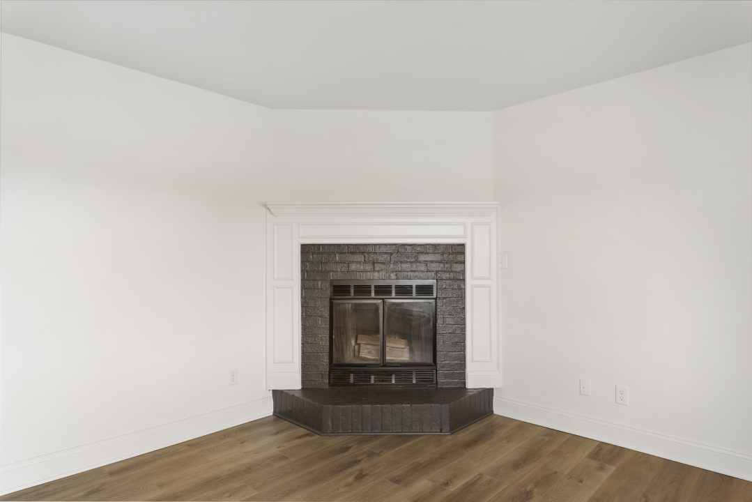 2803 Maplewood Drive Champaign, IL 61821 - Photo 5 of 39 a living room with a fireplace and a wooden floor