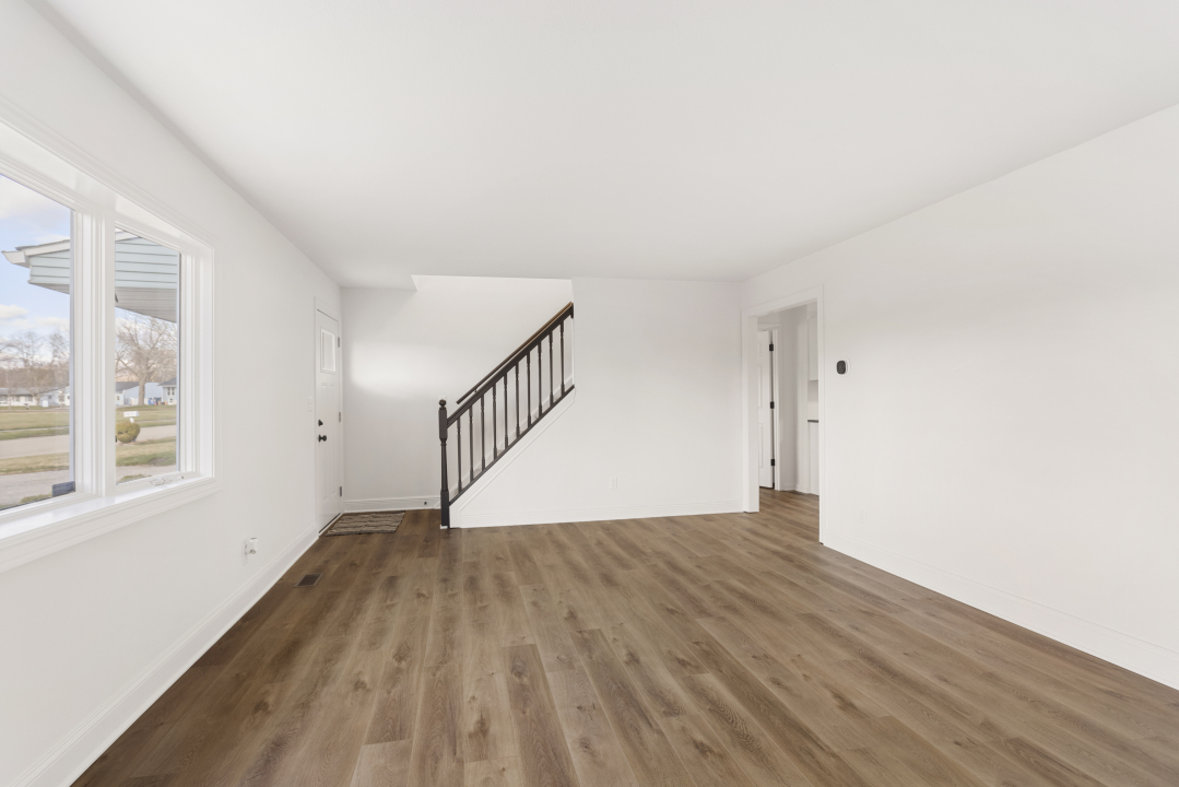 2803 Maplewood Drive Champaign, IL 61821 - Photo 7 of 39 a view of empty room with wooden floor and fan