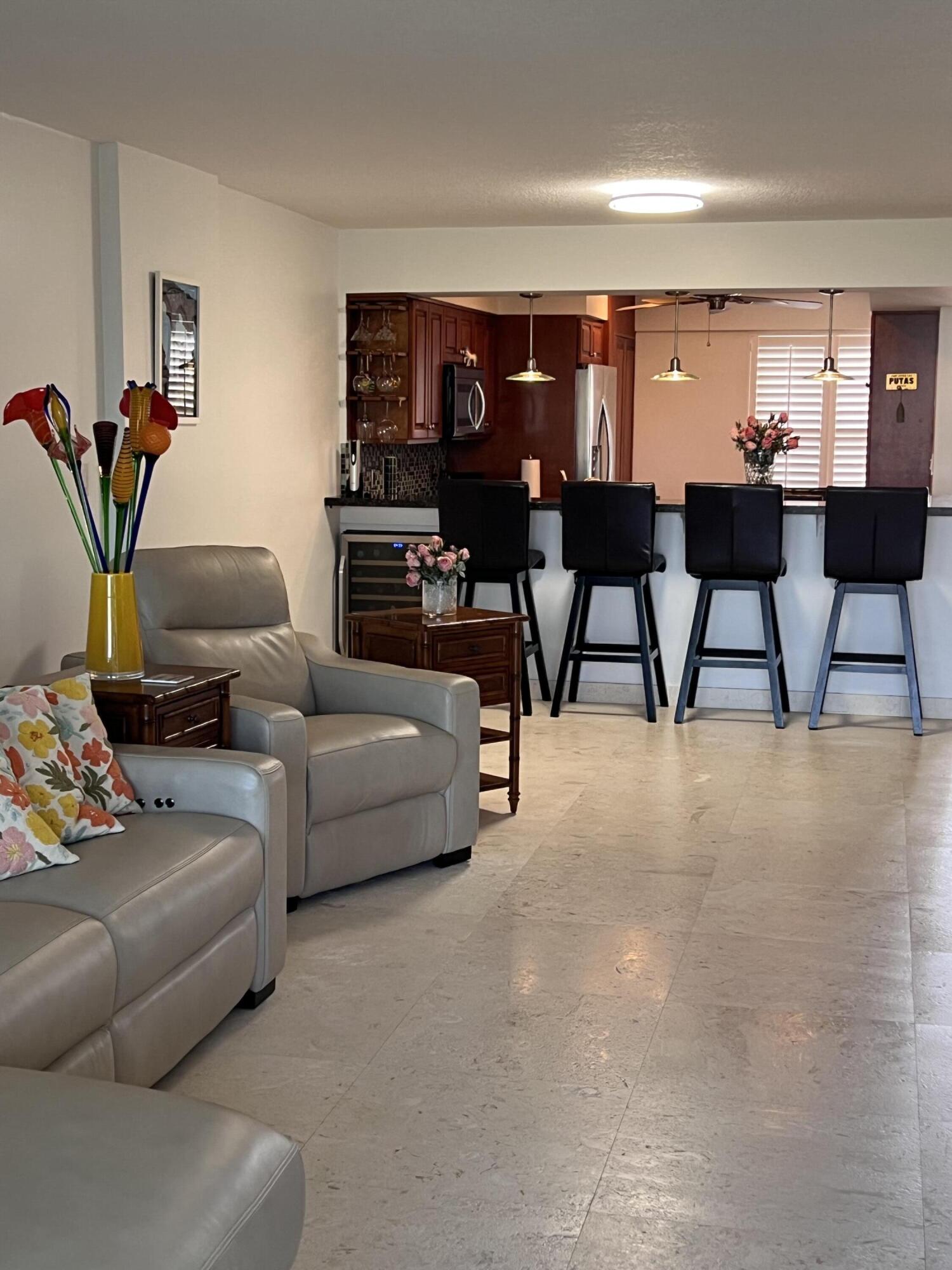 1629 Riverview Road, Unit 716 Deerfield Beach, FL 33441 - Photo 12 of 44 a living room with furniture and a potted plant