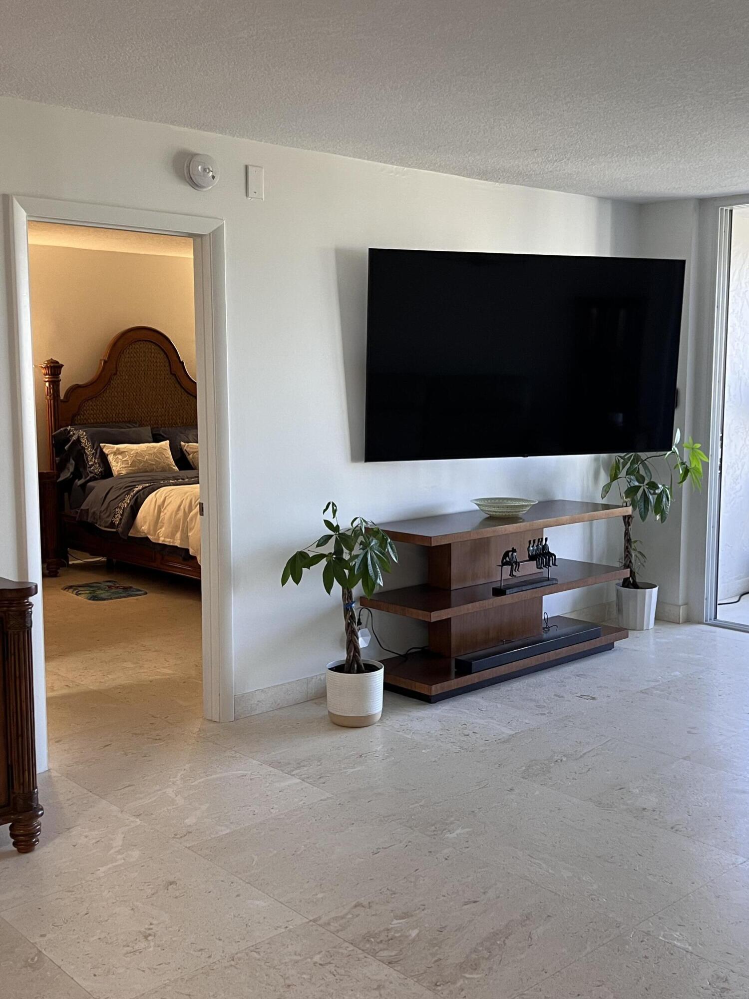 1629 Riverview Road, Unit 716 Deerfield Beach, FL 33441 - Photo 14 of 44 a living room with furniture and a flat screen tv