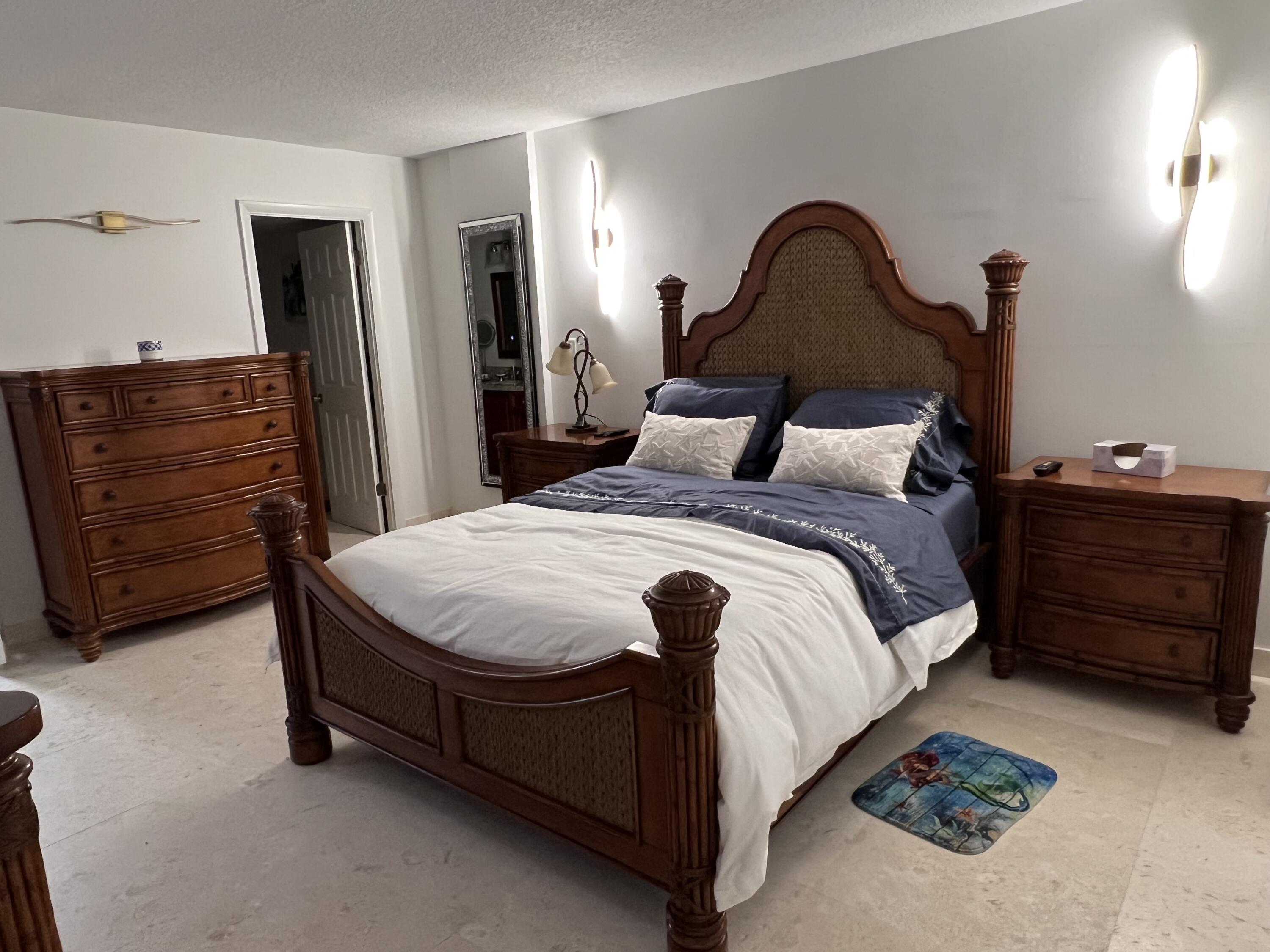 1629 Riverview Road, Unit 716 Deerfield Beach, FL 33441 - Photo 21 of 44 a bed sitting in a bedroom and dresser