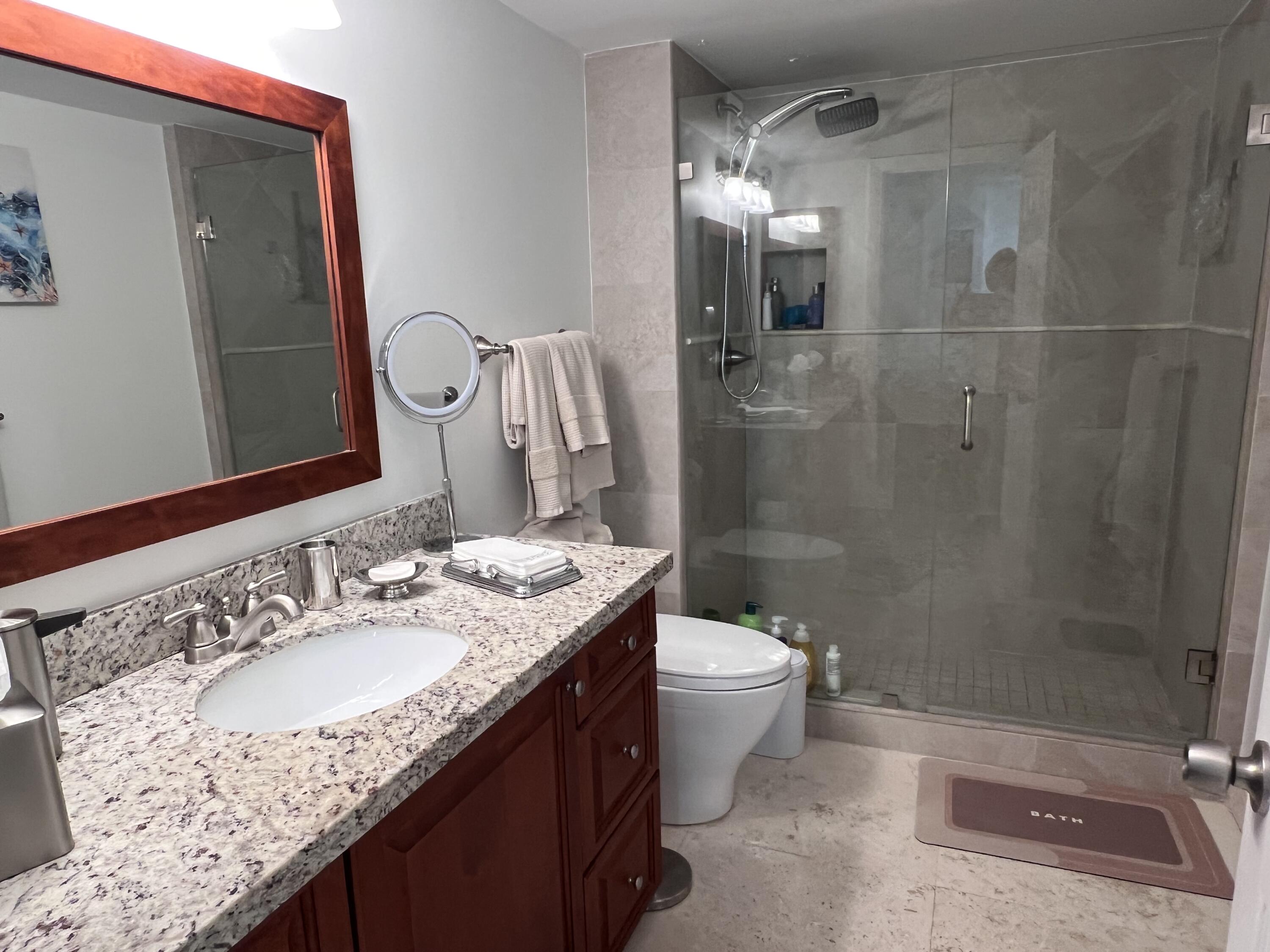 1629 Riverview Road, Unit 716 Deerfield Beach, FL 33441 - Photo 24 of 44 a bathroom with a granite countertop sink toilet and shower
