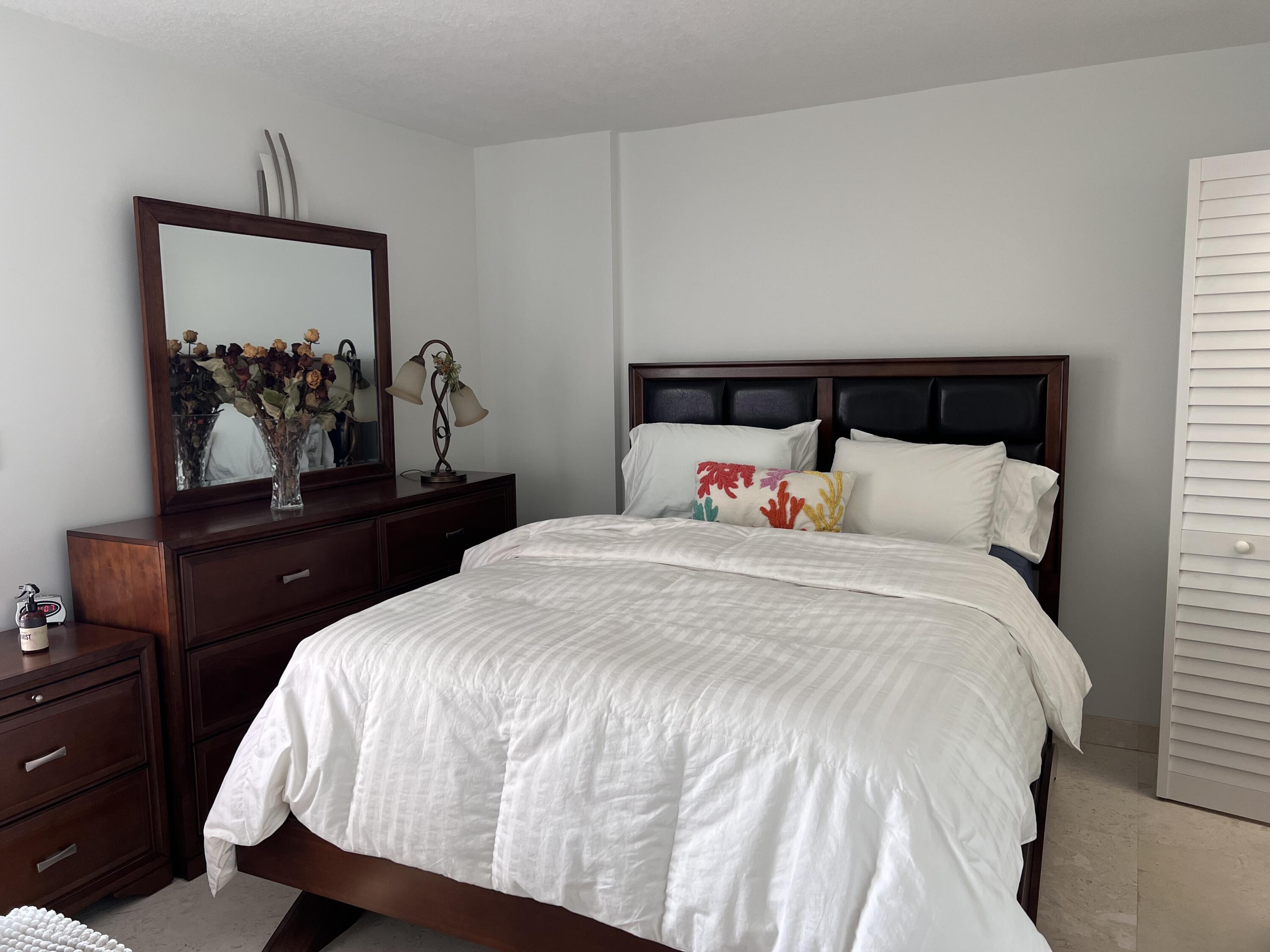 1629 Riverview Road, Unit 716 Deerfield Beach, FL 33441 - Photo 25 of 44 a bedroom with a bed and a dresser