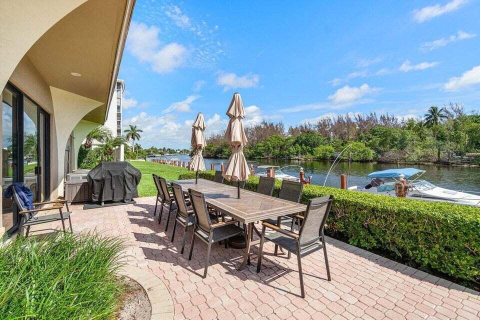 1629 Riverview Road, Unit 716 Deerfield Beach, FL 33441 - Photo 30 of 44 a view of a patio with a table chairs and a table